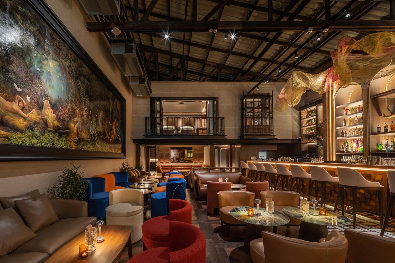 Restaurant interior with red velvet seating and warm timber ceiling — Gratitude Design