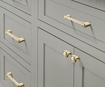 Brass handles on grey drawers